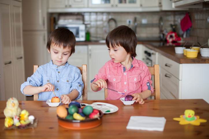 Two boys, coloring eggs for Easter